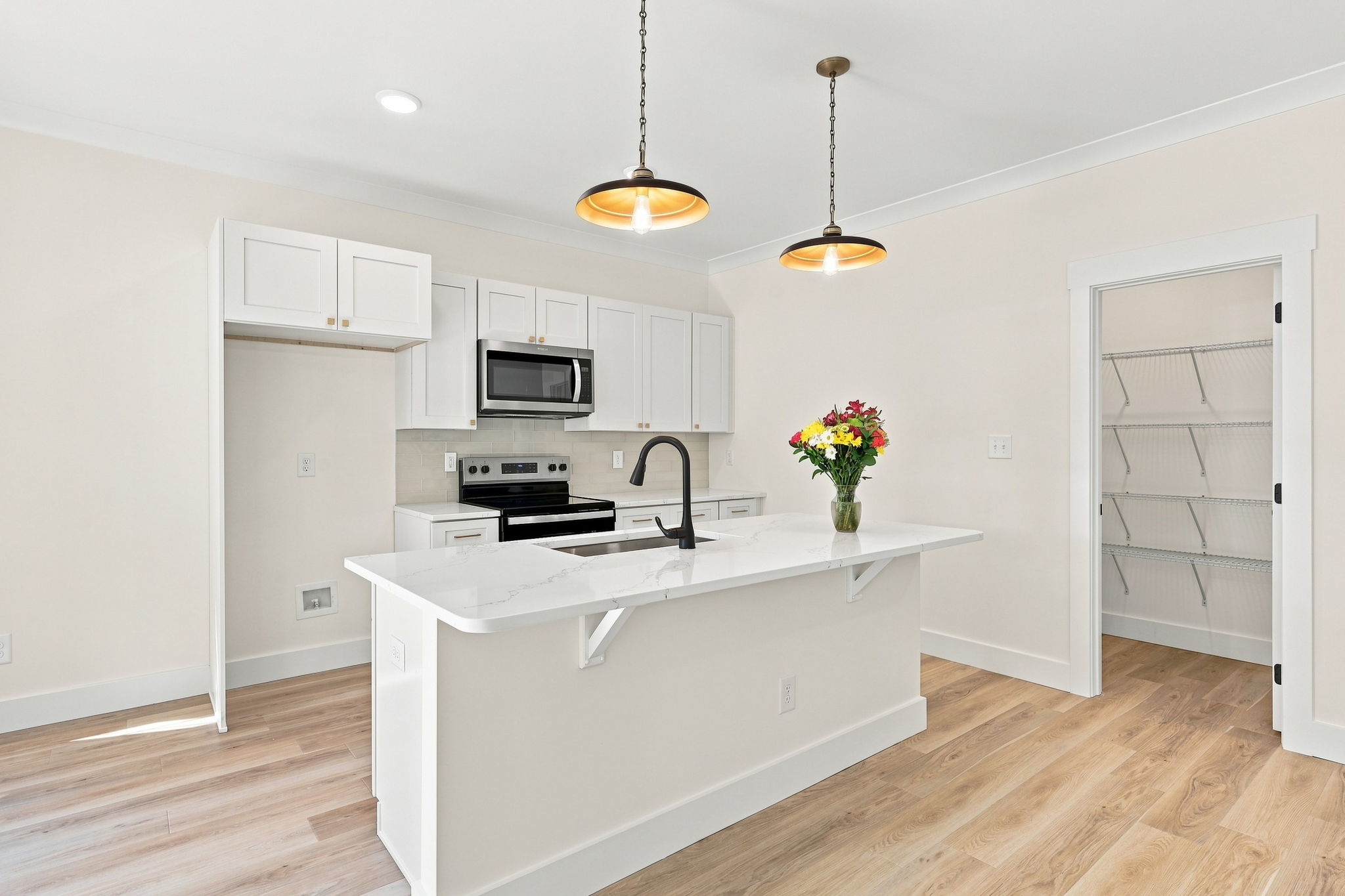 Kitchen with Pantry Access at The Eliora by Covenant Construction Group